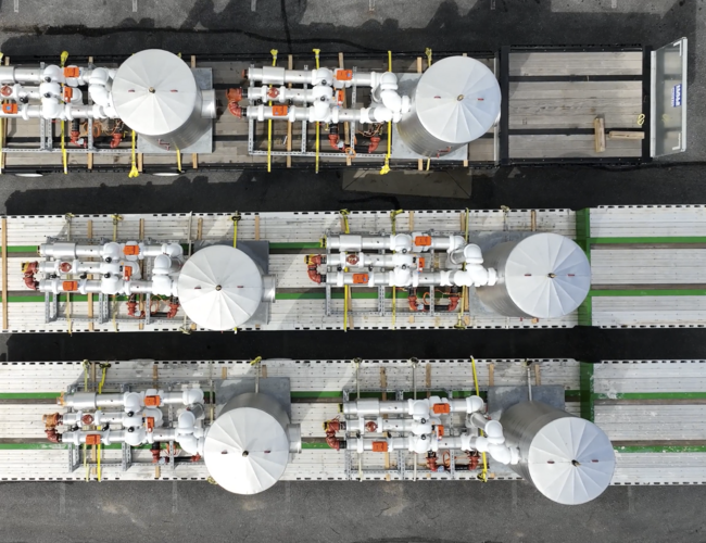 Drone shot of modular solutions modules being loaded onto a trailer to be delivered